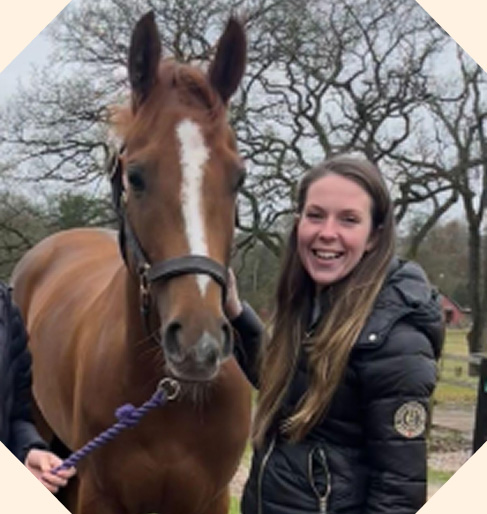 Foxy, a chestnut horse alongside her owner.